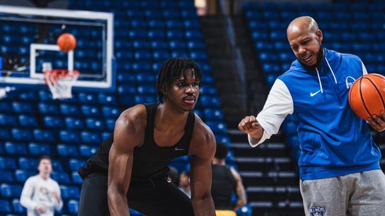 Saint Louis Guard Amari McCottry works on a dribbling drill with Coach Antone Gray
