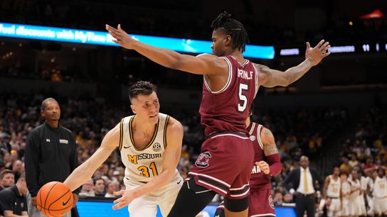 Missouri Tigers guard Caleb Grill (#31) passes the ball while South Carolina Gamecocks forward Nick Pringle (#5) defends during the second half at Mizzou Arena on Feb. 25, 2025, in Columbia, Missouri.