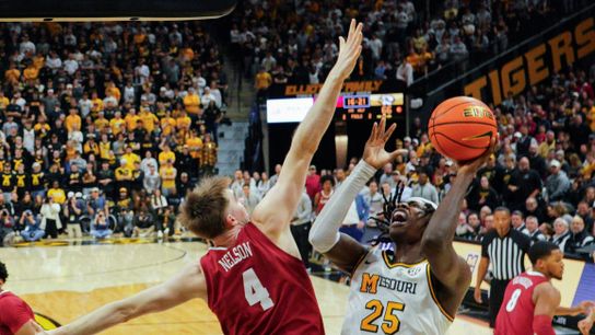 Missouri Tigers guard Mark Mitchell (25) attempts a shot while Alabama Crimson Tide forward Grant Nelson (4) defends during the second half of a college basketball game at Mizzou Arena in Columbia, Missouri, on February 19, 2025.